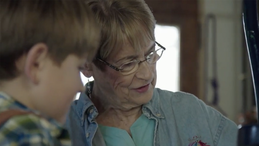 Grandmother and grandson examining object