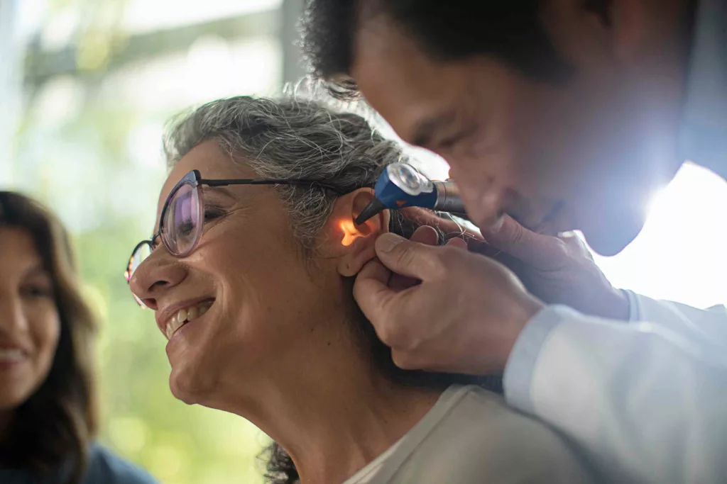 Specialist performing otoscopy on patient