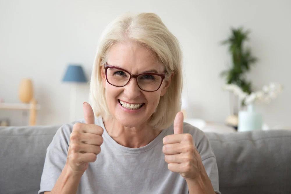 Smiling woman giving thumbsup