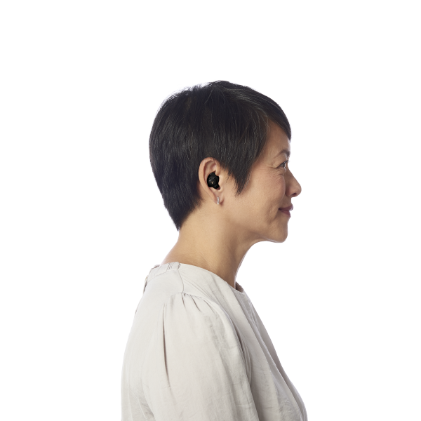 Side profile of middle aged woman wearing hearing aids