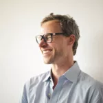Man with glasses laughing
