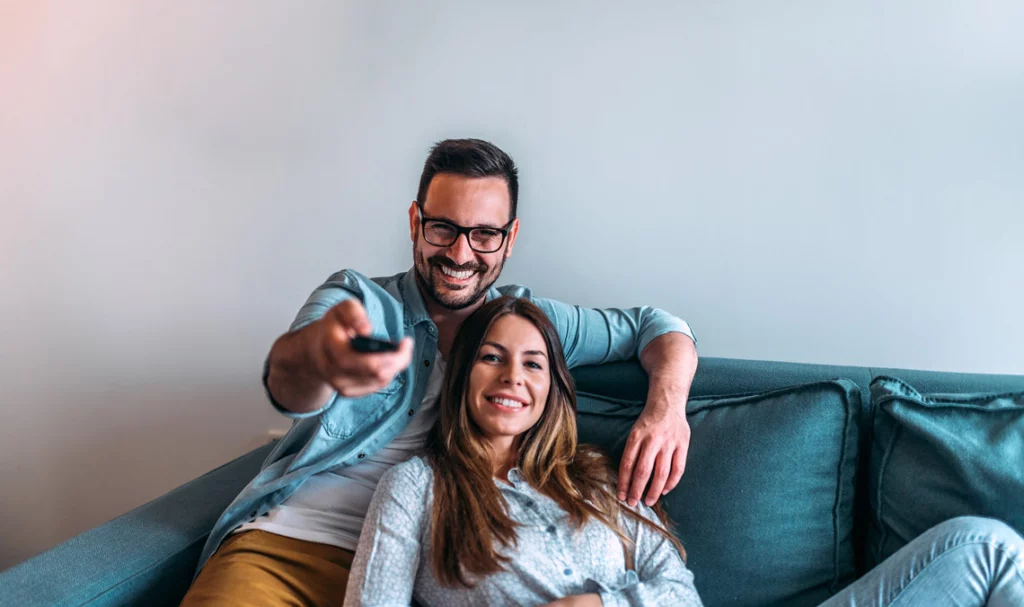 Smiling young couple on couch