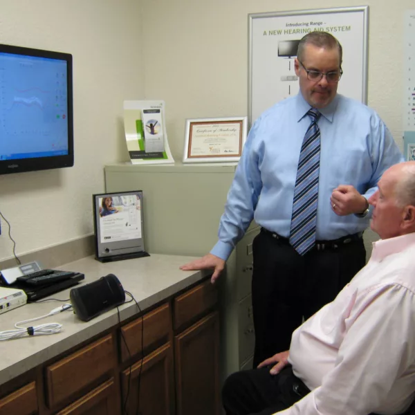 Hearing specialist speaking with patient