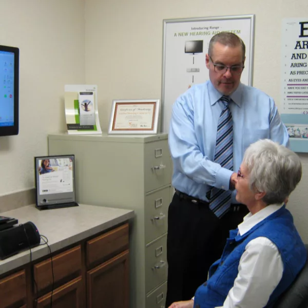 Hearing specialist examining patient's ear