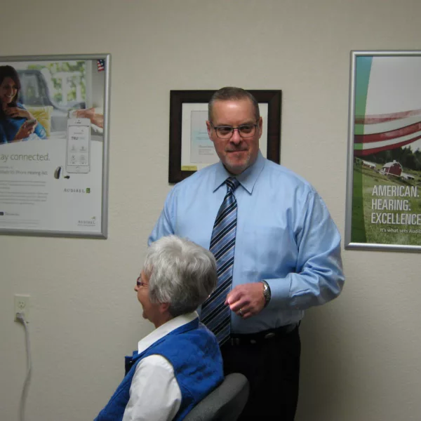 Hearing specialist speaking with patient