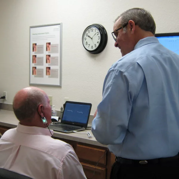 Hearing specialist examining patient's ear