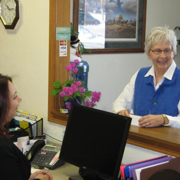 Receptionist speaking with patient