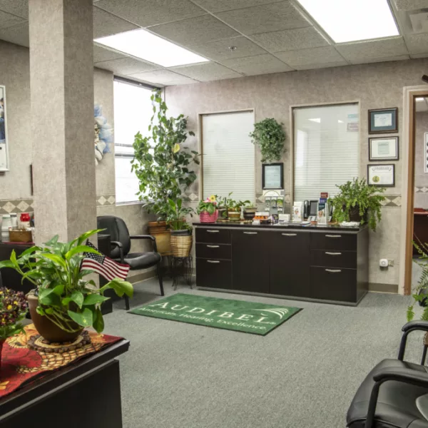 Office waiting room with plants, chairs, carpeted floors