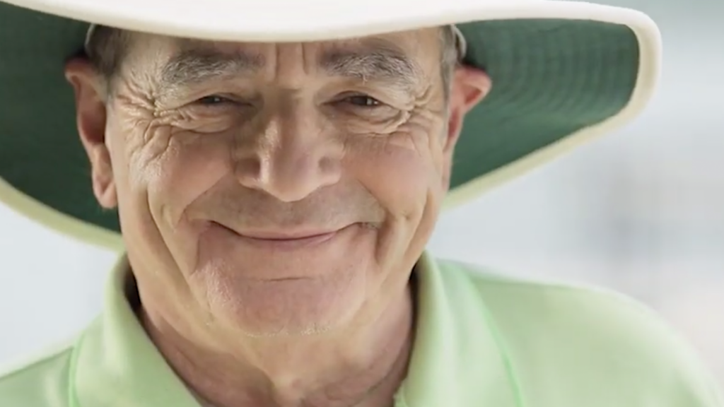 Elderly man in hat smiling