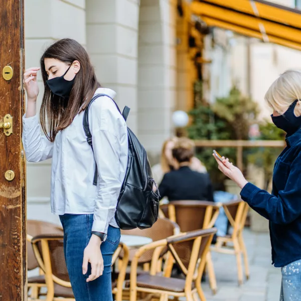 Two people standing outside restaurant