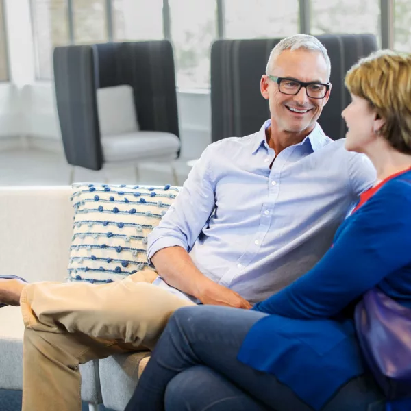 Couple sitting on couch conversing