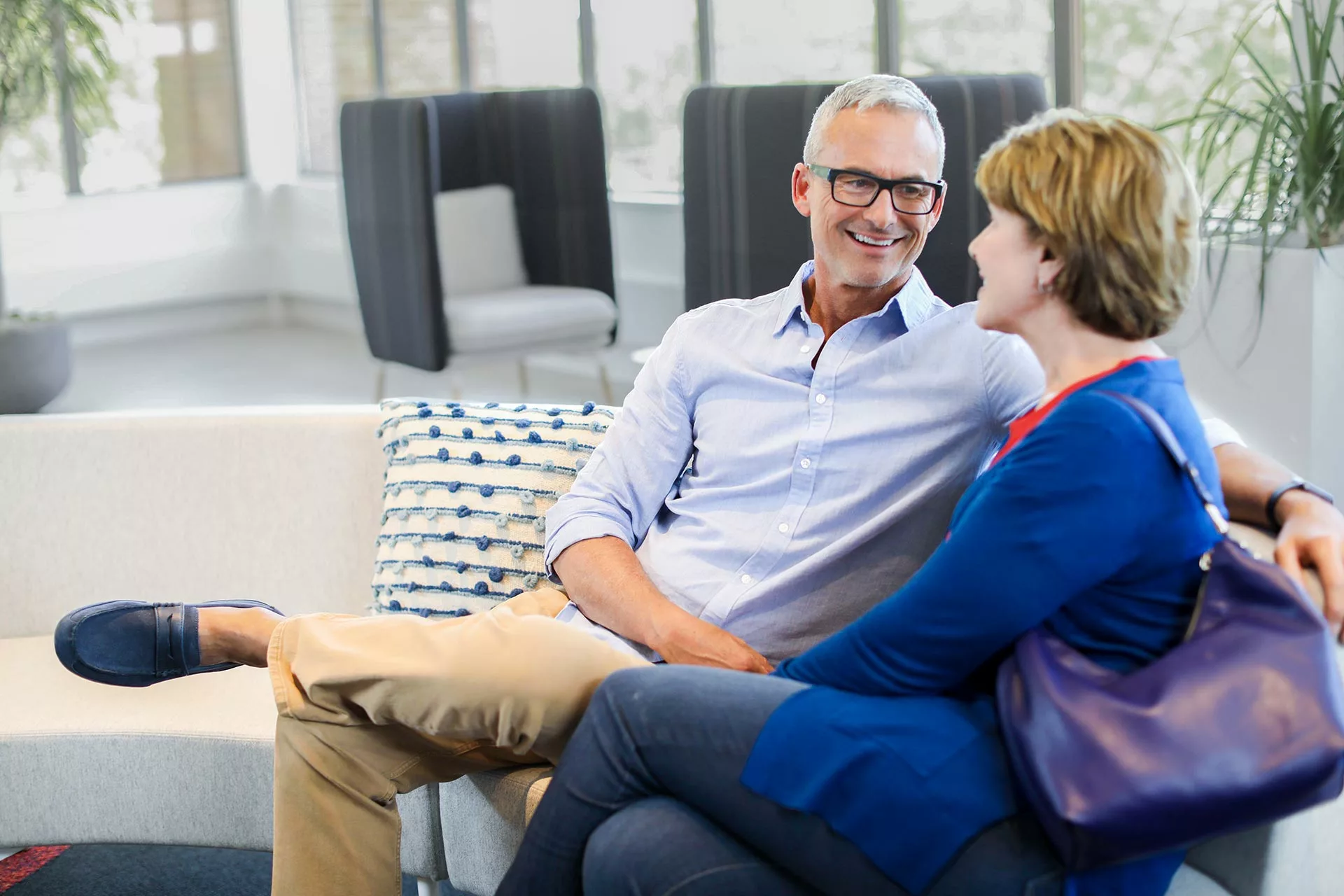 Couple sitting on couch conversing