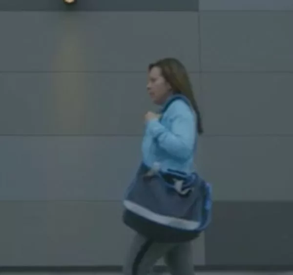 Stacy walking with bag and her hearing aids