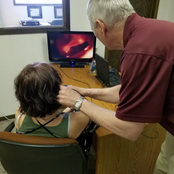 Hearing specialist speaking with a patient