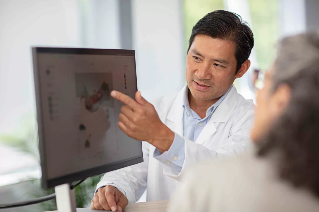 Doctor showing patient computer screen