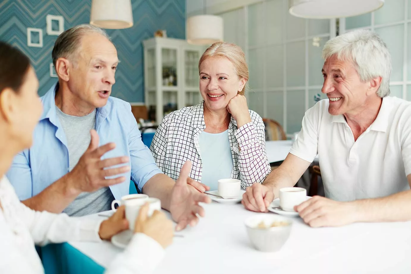 Seniors talking animatedly at a table