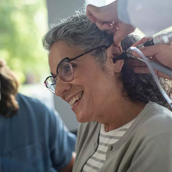 Specialist examining patient's ear