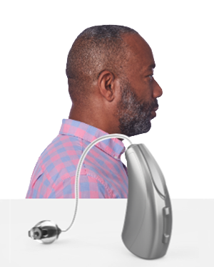 The side profile of a man wearing a Receiver-in-the-canal RIC hearing aid