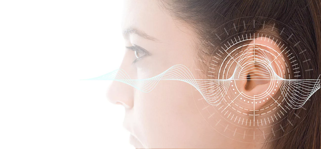 profile of woman's head with a graphic representing sound measurements over her ear