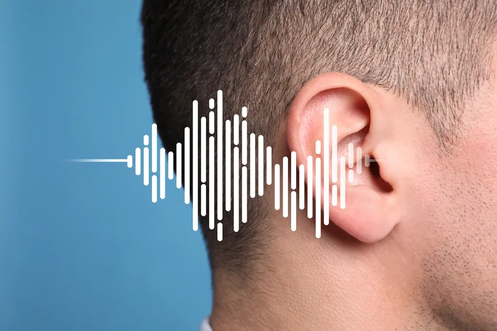 Close up of a man's ear with sound waves pattern in foreground, concept for conductive hearing loss symptoms