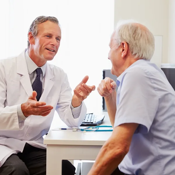 A happy senior man have a consultation with a hearing specialist in a hearing clinic