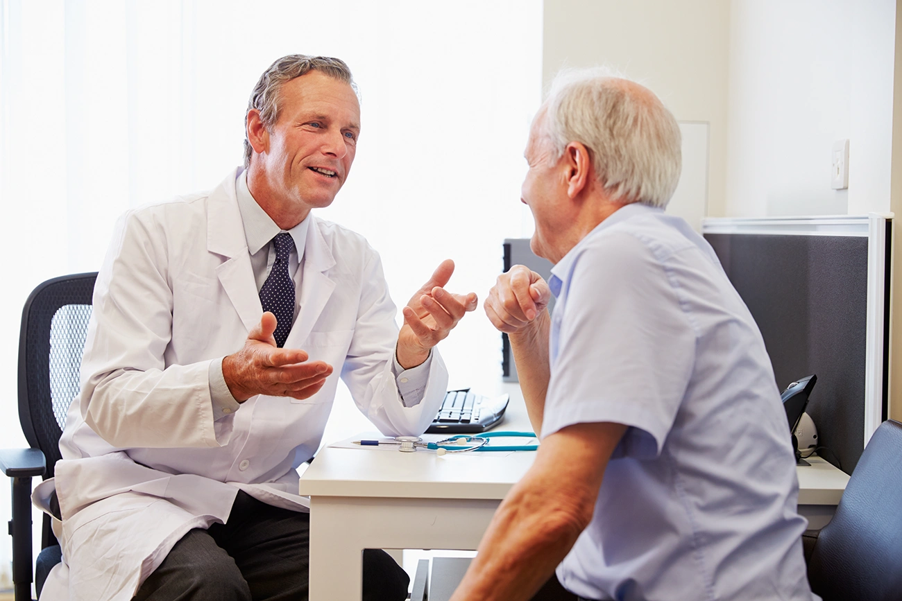 A happy senior man have a consultation with a hearing specialist in a hearing clinic