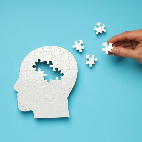 A puzzle in the shape of a brain with some missing pieces, symbolizing the concept of hearing loss and Alzheimer's disease.