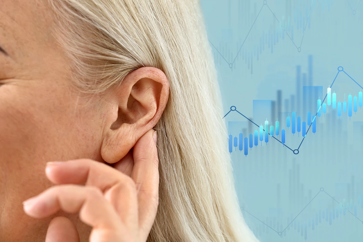 The side profile of a woman holding her hand up to her ear as if to help her hear better, with statistic graphics out of focus in the background, showing the concept of hearing loss statistics in the United States